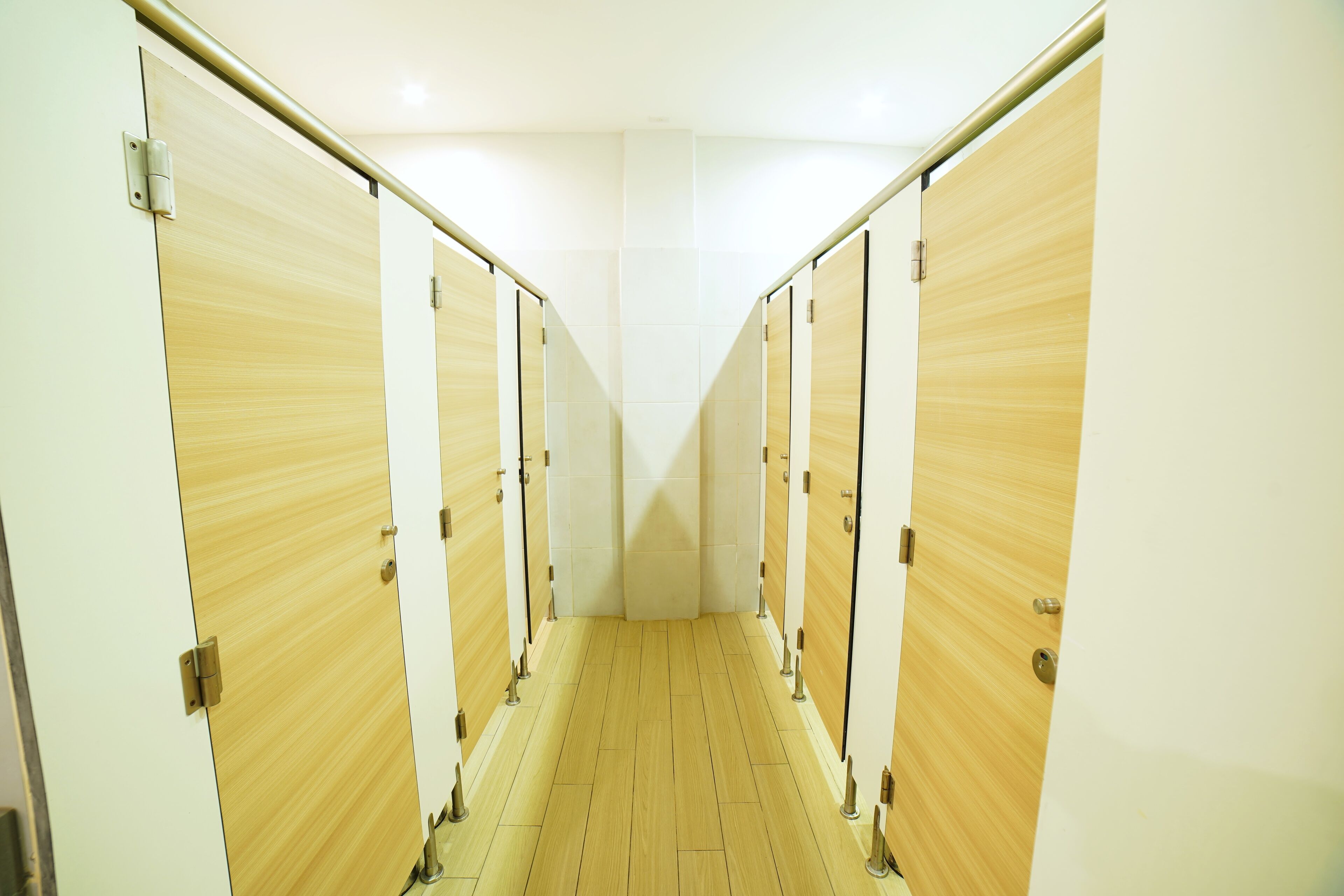 A corridor with wooden lockers and a tiled floor.