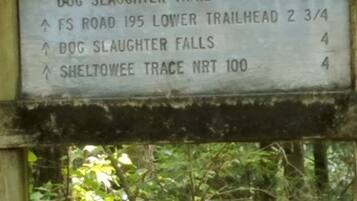 Señal de sendero con indicaciones hacia Dog Slaughter Trail, FS Road 195, entrada inferior del sendero Dog Slaughter Falls y Sheltoowe Trace NRT.