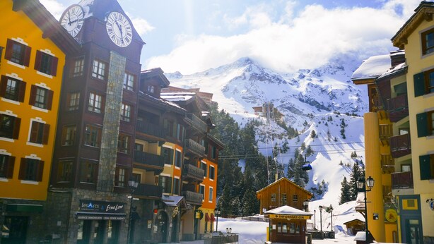 A snow-covered town with colorful buildings, a clock tower, and a mountain in the background. - # Rustic, spacious, Ski-In-Ski-Out, Four Bedroom Chalet Apartment in Les Arc1950 (Bourg-Saint-Maurice)