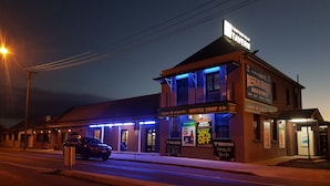 A building with a sign for 'Tenterfield Tavern' and a 'Bottle Shop' on the ground floor. - Tenterfield Tavern and Motor Inn (Tenterfield)