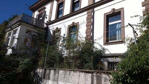A multi-story building with a white facade and brown trim.