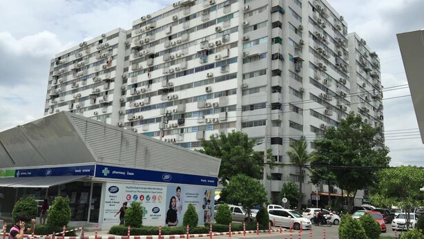 A multi-story residential building with balconies and air conditioning units. - T9 Muang Thong Thani Condo (Pak Kret)