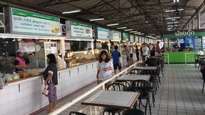 A food court with multiple food stalls and seating areas. - T9 Muang Thong Thani Condo (Pak Kret)