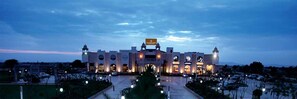 A large building with a prominent sign reading "GRAN CHIMA" at the entrance, surrounded by a parking lot and greenery. - The Lal Vilas Hotel & Resort (Behror)