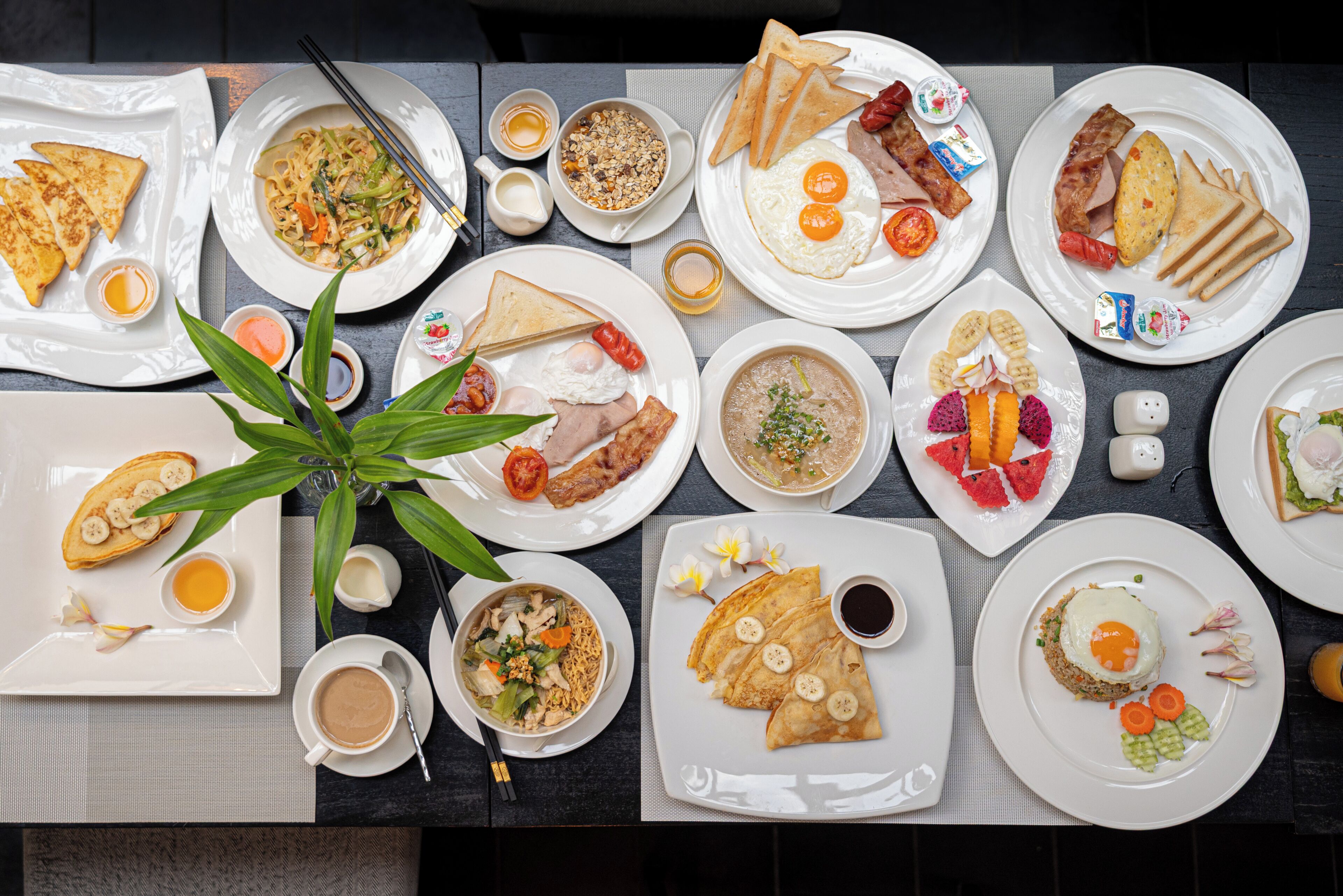 A table with various dishes, including eggs, toast, and soup.