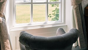 A room with a large window, a chair, and curtains. - The Queens Hotel Lytham (Lytham St. Anne's)