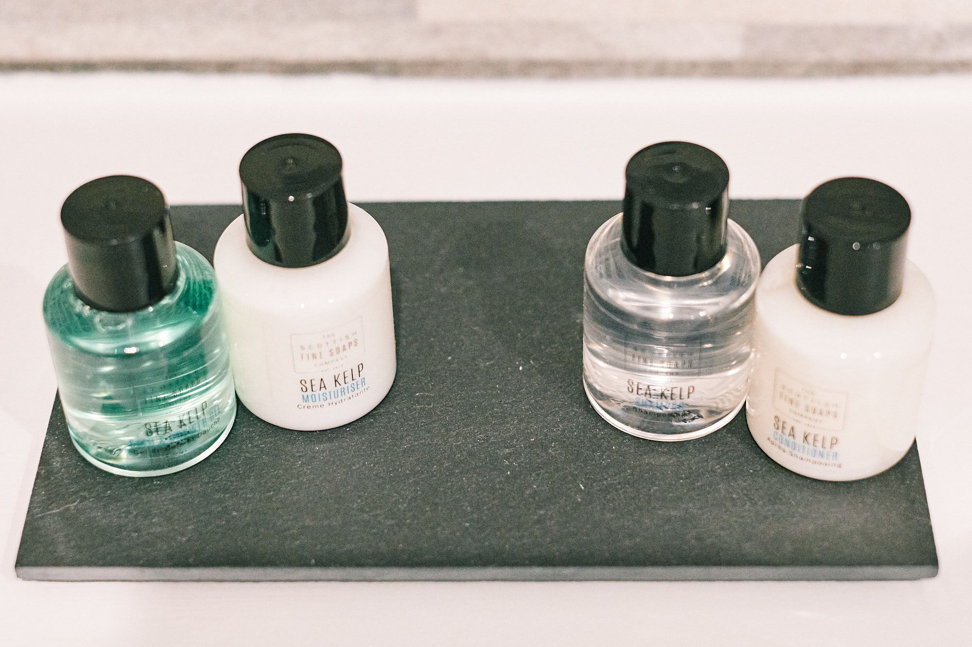 Four bottles of Sea Kelp products on a dark surface.