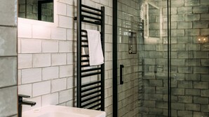 A bathroom with a white sink, a glass shower enclosure, and a toilet. - The Queens Hotel Lytham (Lytham St. Anne's)