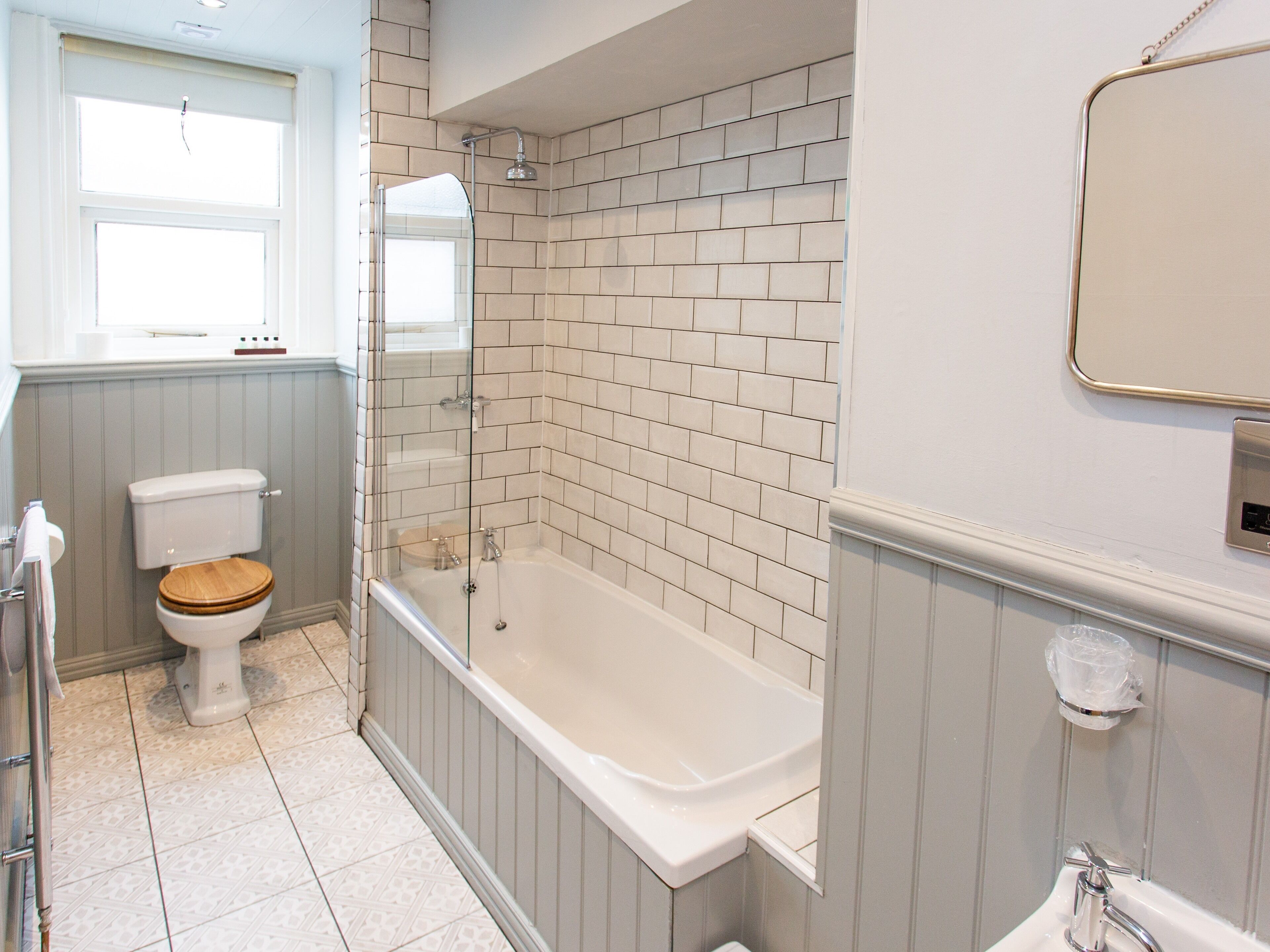 A bathroom with a toilet, a bathtub, and a shower.