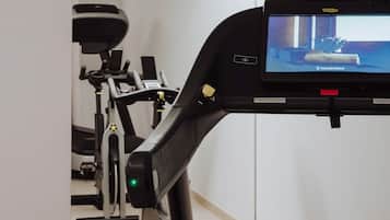A stationary bike with a digital display and a handlebar.