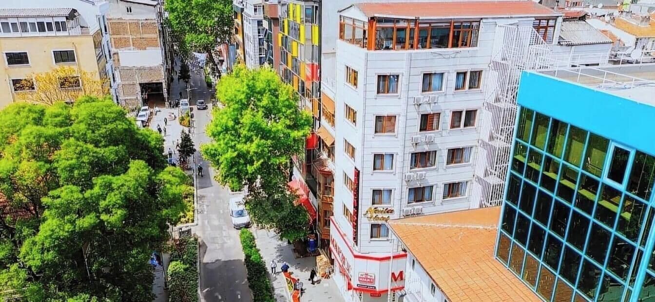 A multi-story building with a modern design, featuring a mix of residential and commercial spaces.