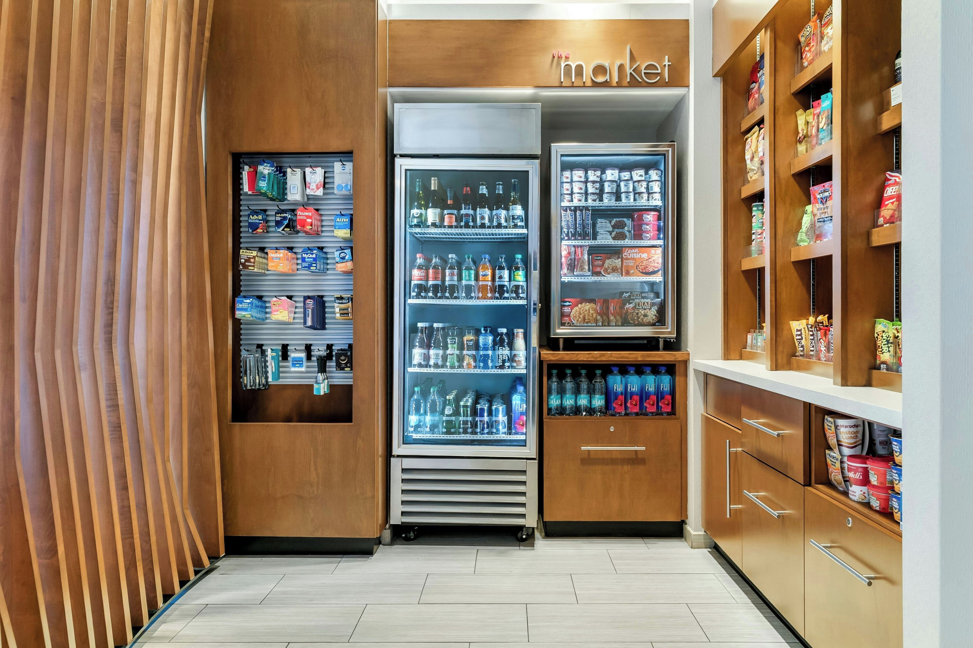 A store with shelves stocked with various products, a refrigerated section, and a section with packaged goods.