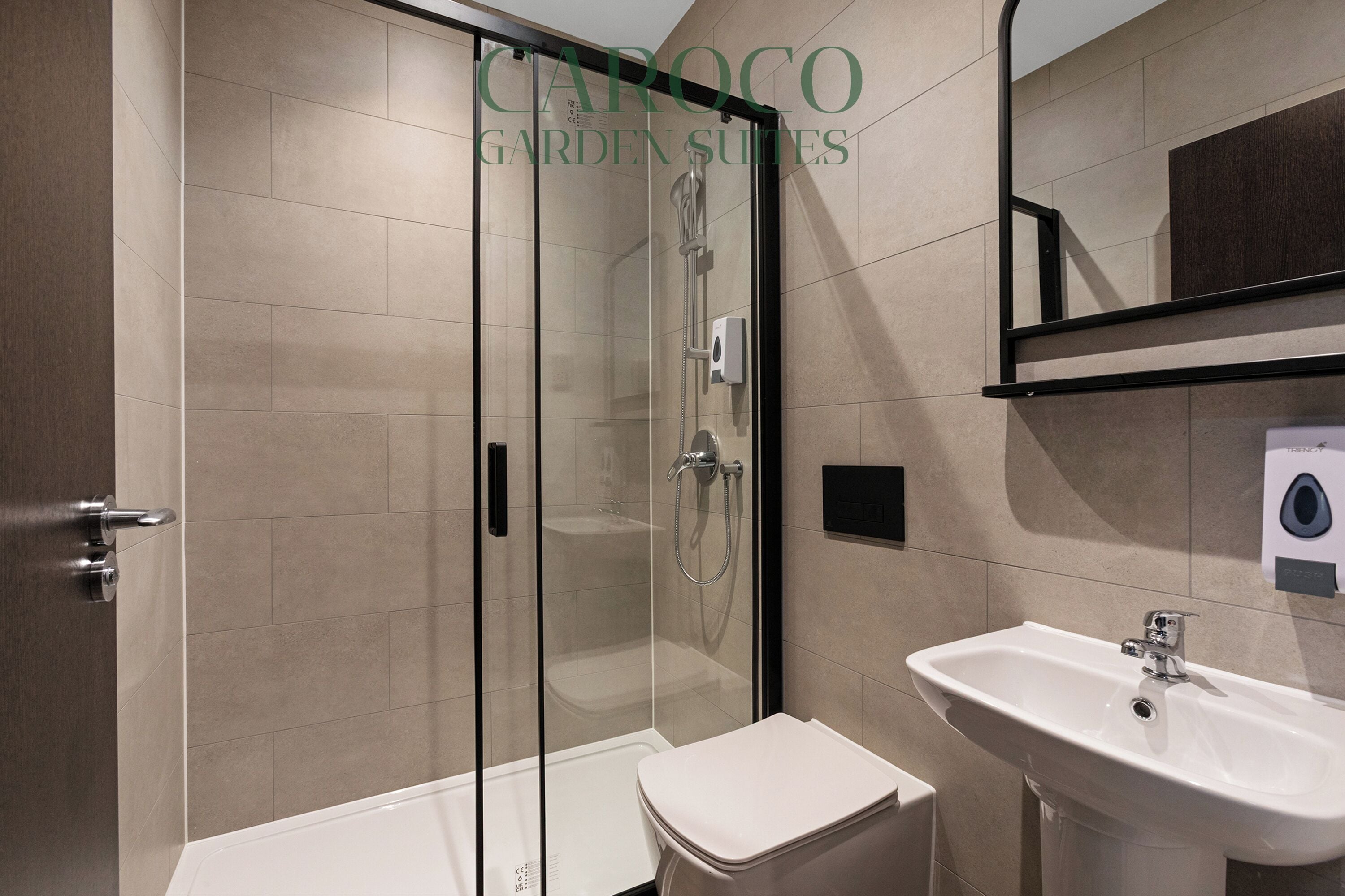 A modern bathroom with a glass-enclosed shower, a white sink, and a toilet.