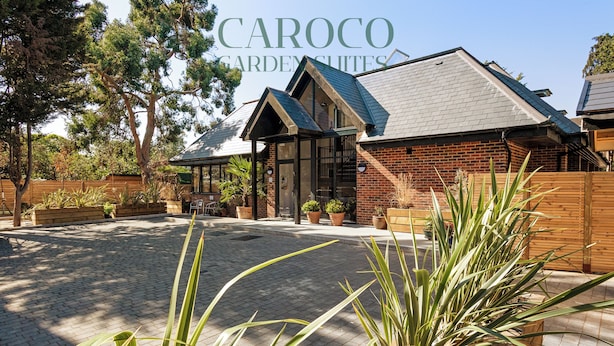 A Caroco Garden Suites building with a brick exterior, large windows, and a paved courtyard. - Westciti Caroco Aparthotel (Croydon)