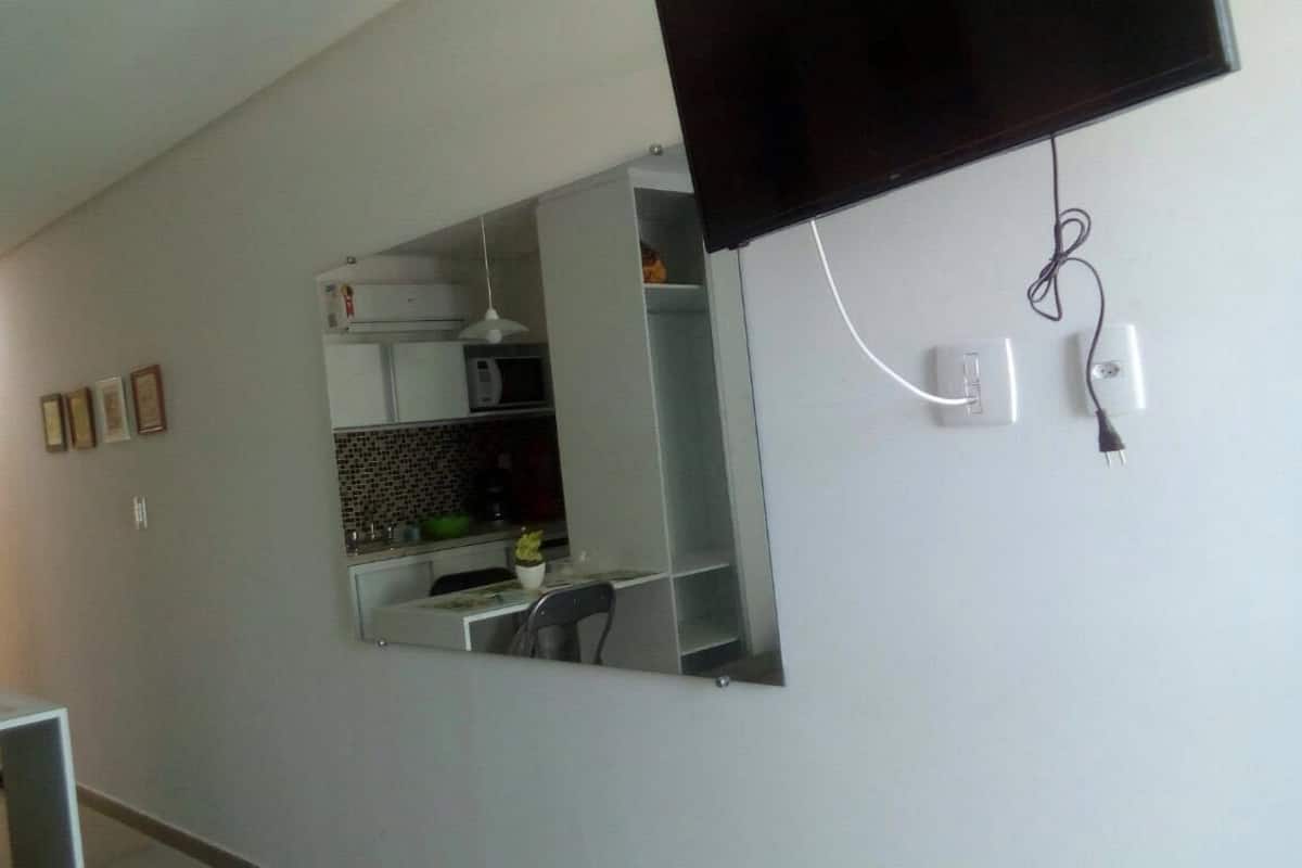 A modern kitchen with a built-in microwave, a sink, and a dining area.