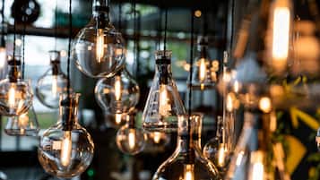 A collection of glass light fixtures with a clear bulb and a scale marked with measurements.