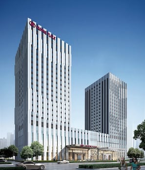 A modern high-rise building with a prominent "Crowne Plaza" sign at the top. - Crowne Plaza Harbin Songbei by IHG (Harbin)