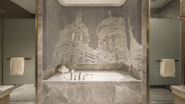 A modern bathroom with a large bathtub, a shower area, and a decorative wall with a mosaic pattern. - Crowne Plaza Harbin Songbei by IHG (Harbin)