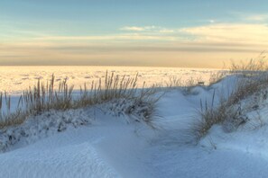 A snowy landscape with a path leading to the water. - Holiday Inn Express and Suites Portage by IHG (Portage)