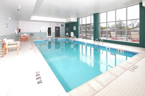 An indoor swimming pool with clear water, a lifeguard chair, and a pool lift. - Holiday Inn Hotels and Suites Mount Pleasant by IHG (Mount Pleasant)
