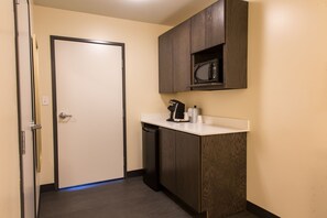 A compact kitchenette with a microwave, coffee maker, and dishwasher. - Holiday Inn Hotels and Suites Mount Pleasant by IHG (Mount Pleasant)