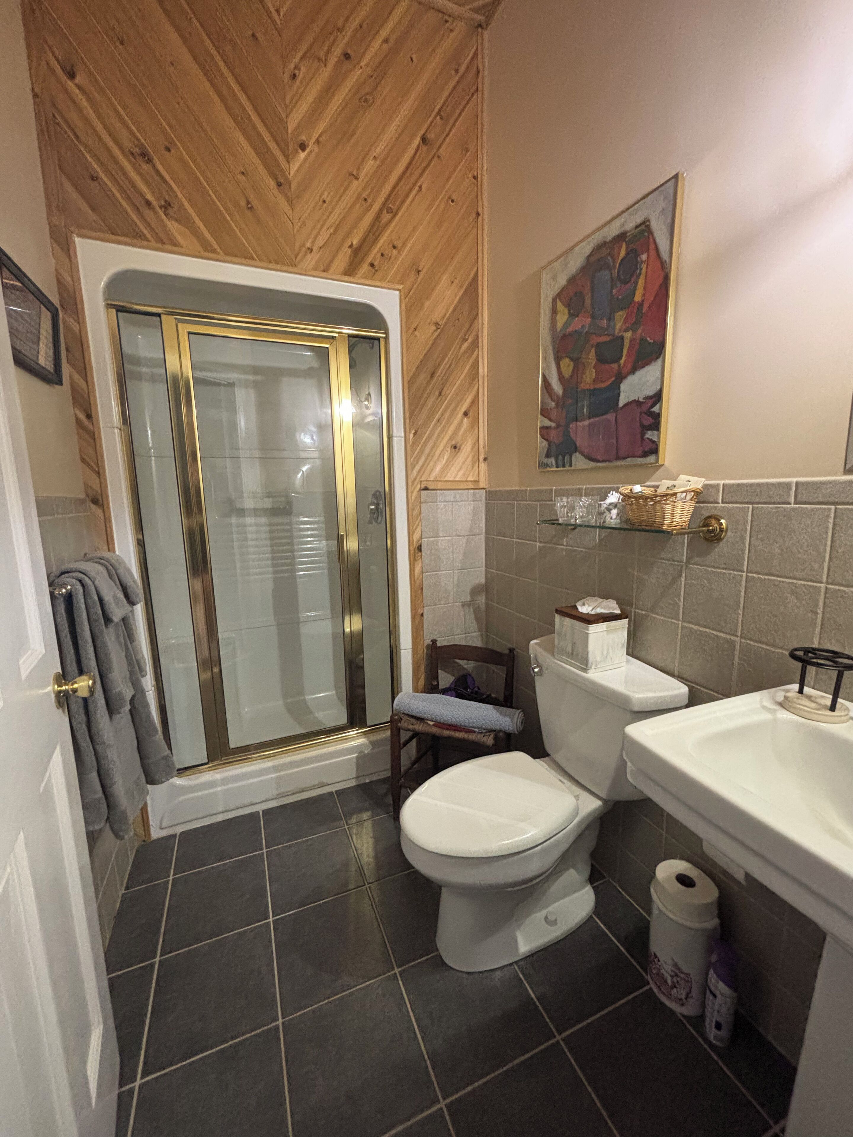 A bathroom with a shower, toilet, and sink.