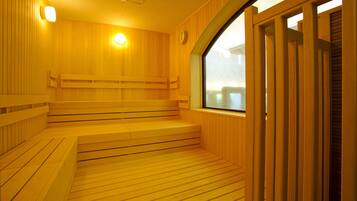 A wooden sauna with benches and steps, a clock on the wall, and a window.