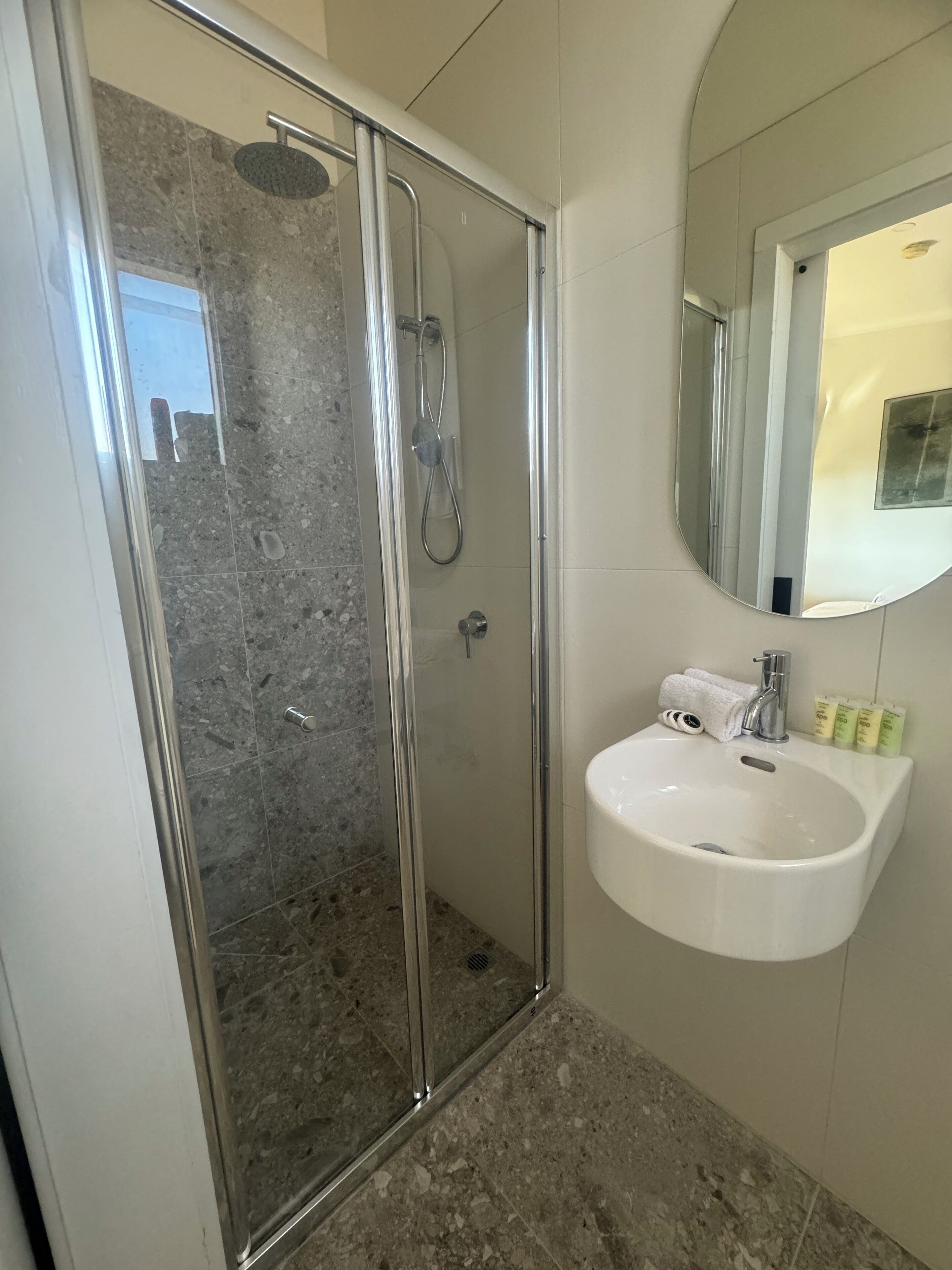 Shower, rainfall showerhead, hair dryer, towels