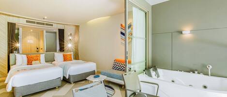 A modern hotel room with two beds, a large bathtub, and a seating area with a table and chairs.
