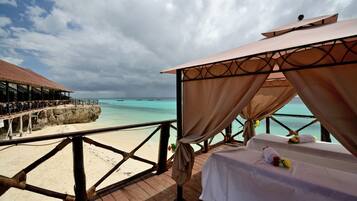 Relax by the ocean with a serene beachfront view from the comfort of your bed.