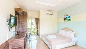 A hotel room with a bed, a desk with a computer, a TV, and a window with curtains. - Krabi Avahill (Krabi)