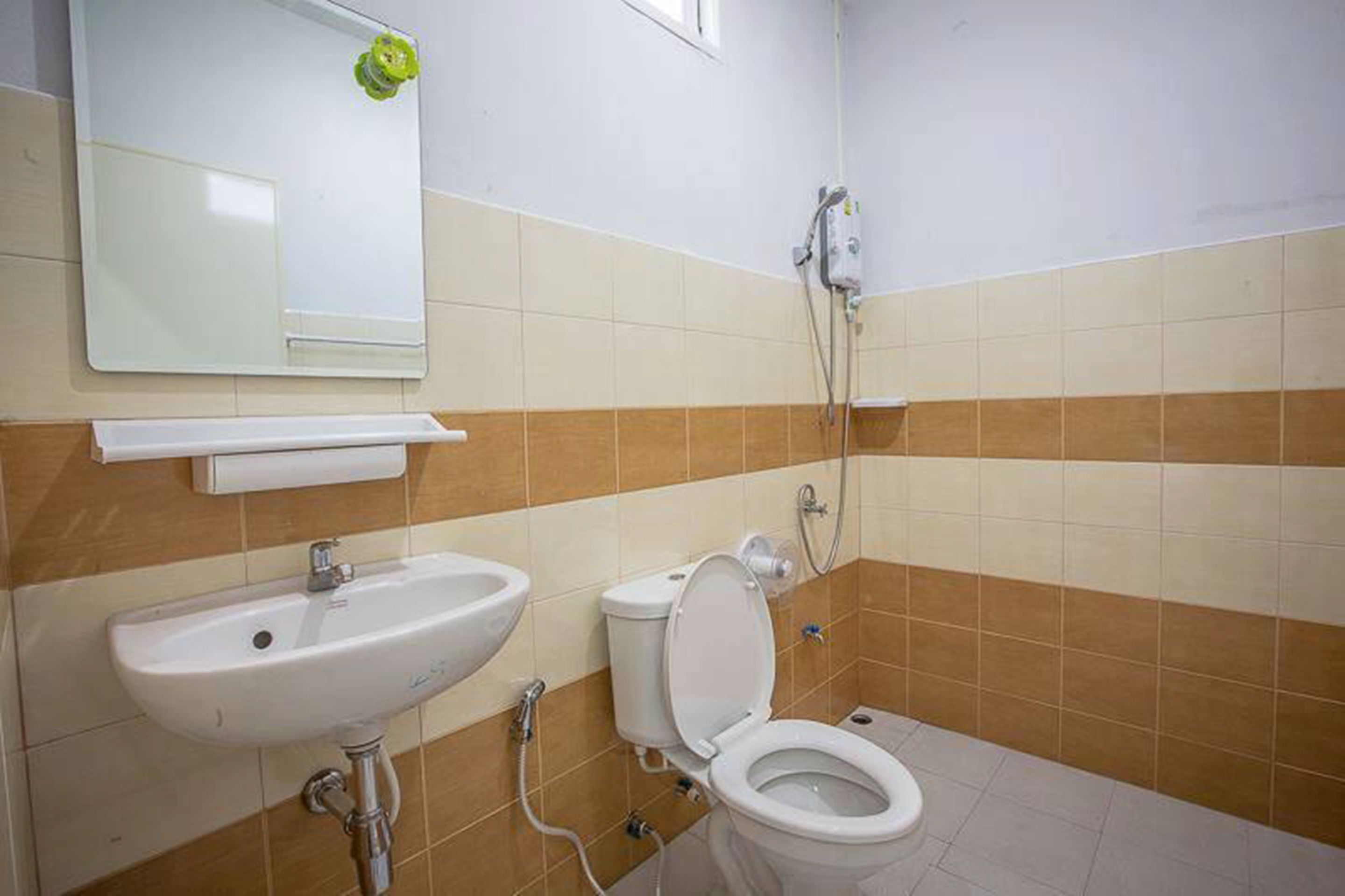 A bathroom with a sink, toilet, and shower.