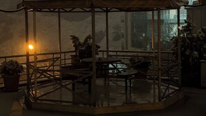 A gazebo with a roof and a glass enclosure, surrounded by potted plants and tables. - S&L Boutique Hotel  (Tbilisi)