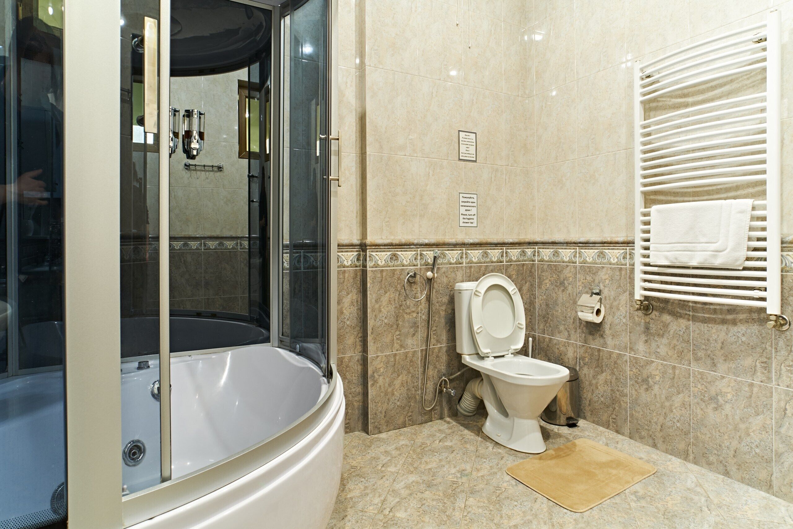 A bathroom with a bathtub, toilet, and shower.