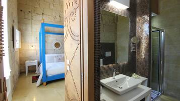 A modern bathroom with a large mirror, a sink, and a shower.