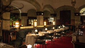 A formal dining room with multiple tables and chairs, a red carpet, and a chandelier. - Bank Hotel, a member of Small Luxury Hotels of The World (Stockholm)