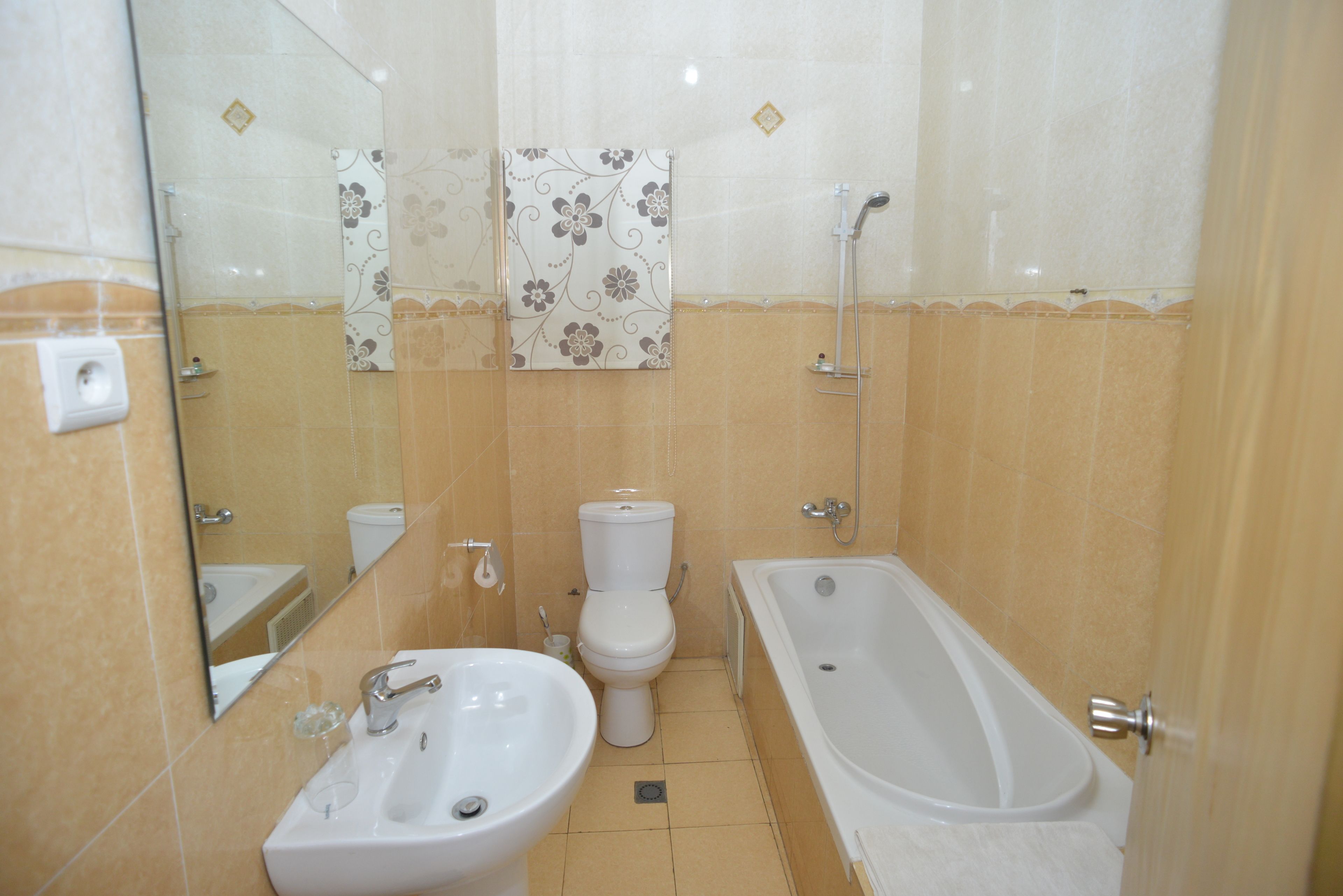 A bathroom with a sink, toilet, and bathtub.