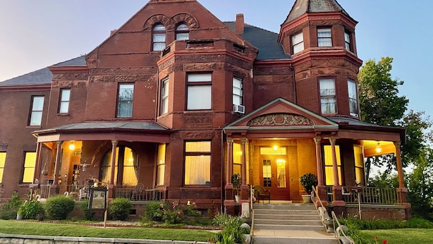 A large, historic brick building with a prominent tower and a grand entrance. - Vineyard Mansion & Carriage House Bed & Breakfast (St. Joseph)
