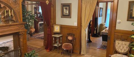 A traditional interior with a fireplace, wooden furniture, and a chandelier.