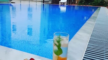 Piscina externa sazonal, funciona das 10h30 às 19h30, guarda-sóis