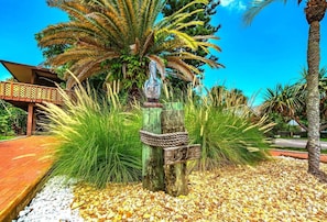 Relax on a wooden deck surrounded by lush greenery and enjoy the serene atmosphere.