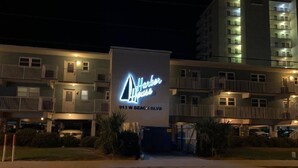 A hotel with a large illuminated sign reading "Harbor House" at 913 W Beach Blvd. - Harbor House-Unit B21-Beachfront Paradise in the Heart of Gulf Shores (Gulf Shores)