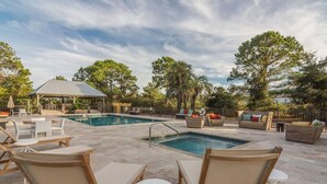 A pool area with lounge chairs and a covered seating area. - Walk to the beach! 2 bedroom 2 bath condo with a loft.  (Santa Rosa Beach)