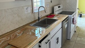 A modern kitchen with a stainless steel sink, a built-in oven, and a microwave. -   Ranch House 3 Blocks to  Beach (Panama City Beach)