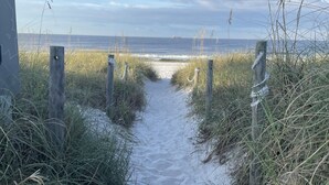 A sandy path leading to a beach with a wooden fence on either side. -   Ranch House 3 Blocks to  Beach (Panama City Beach)
