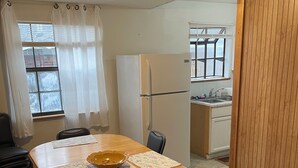 A compact kitchen with a refrigerator, sink, and window. -   Ranch House 3 Blocks to  Beach (Panama City Beach)