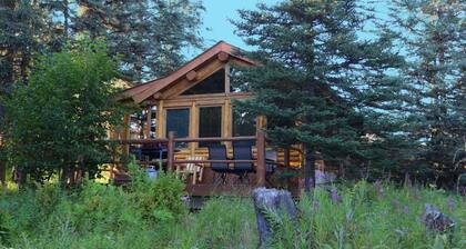 Unique Alaskan log home in trees & wild flowers on 14-acre private homestead.