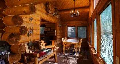 Unique Alaskan log home in trees & wild flowers on 14-acre private homestead.