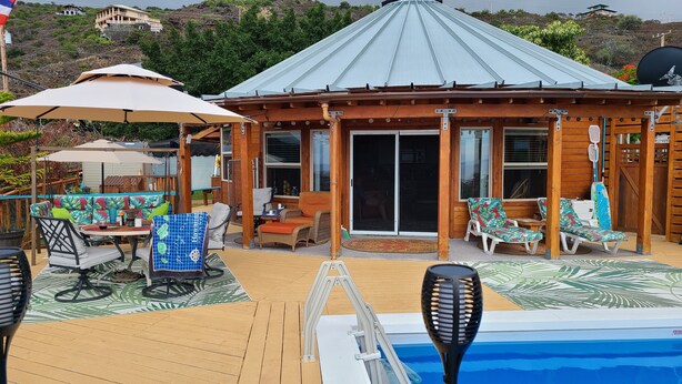 A wooden deck with outdoor furniture, a pool, and a covered patio area. -  New Round House With Pool 180 Degree Ocean View 13% discount for 7 nights  (Captain Cook)