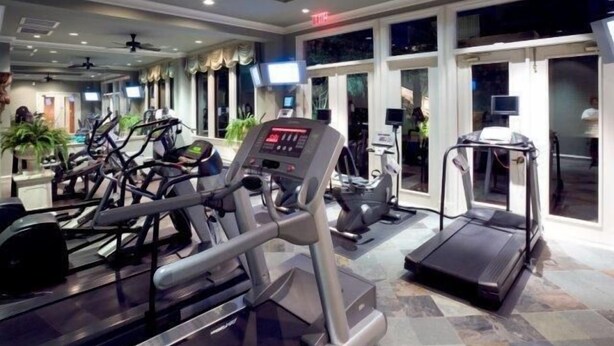 A gym with treadmills, elliptical machines, and a stationary bike. - Fabulous Turtle Creek Location! (Dallas)